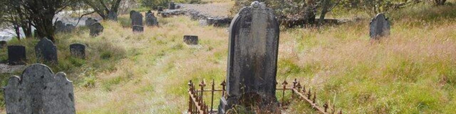 Churchyard and Demolished Church, Dylife Beyond the central headstone the base of Dylife's former church, now demolished, can be seen.