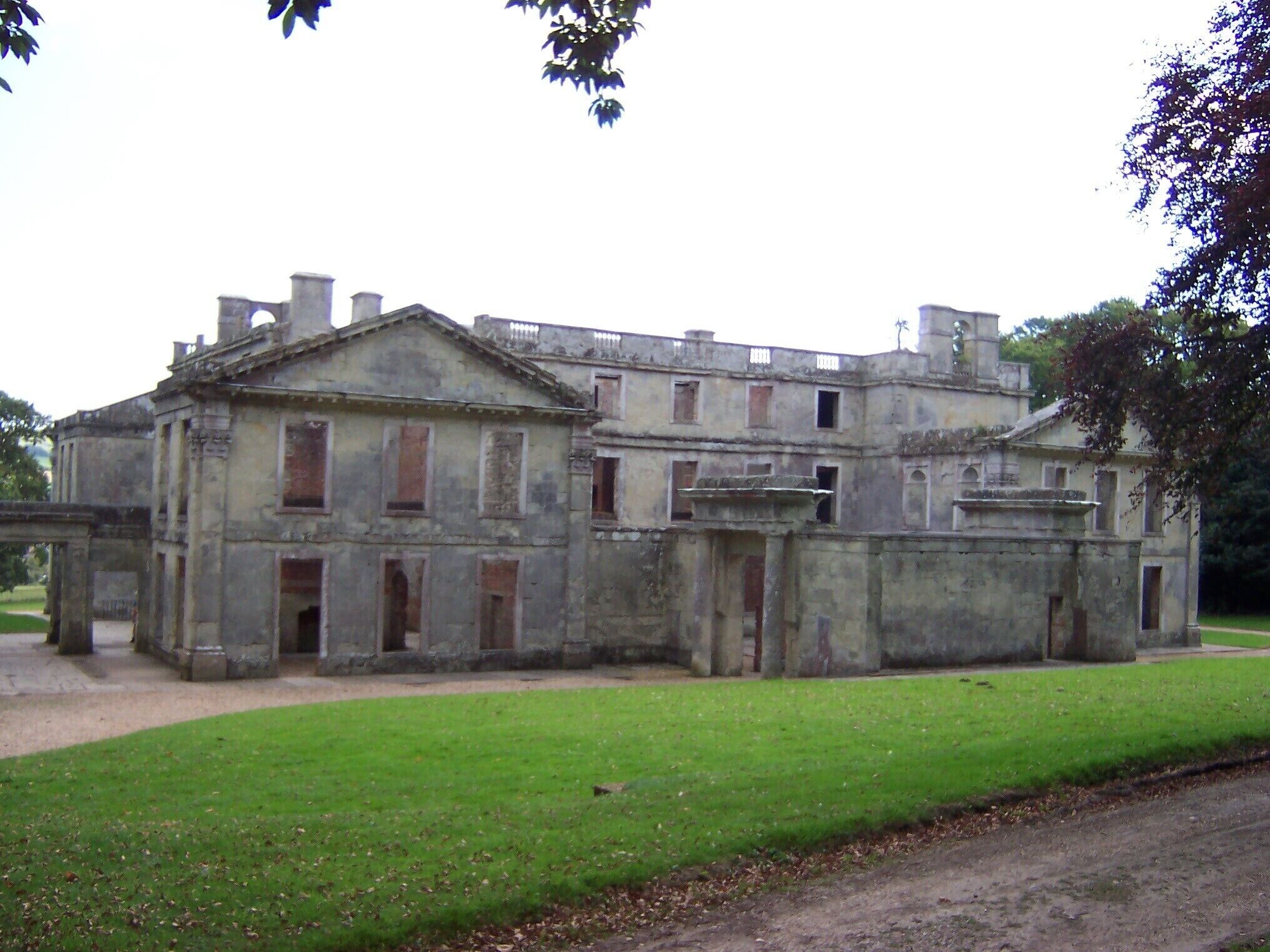 An old, large stone building with multiple windows and a central entrance.