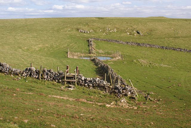Dew pond on the Weaver Hills The land around the Weaver Hills is now Open Access land and stiles have been built to enable easy crossing of dry stone walls.
