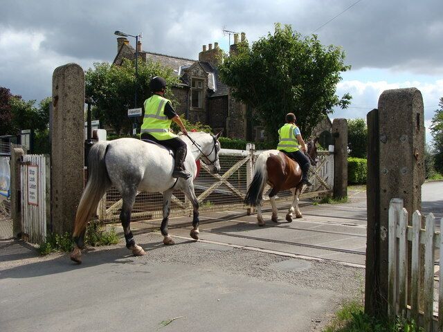 Level crossing at Fiskerton Station - with horse riders The Trent Valley Equestrian Centre is not far away.