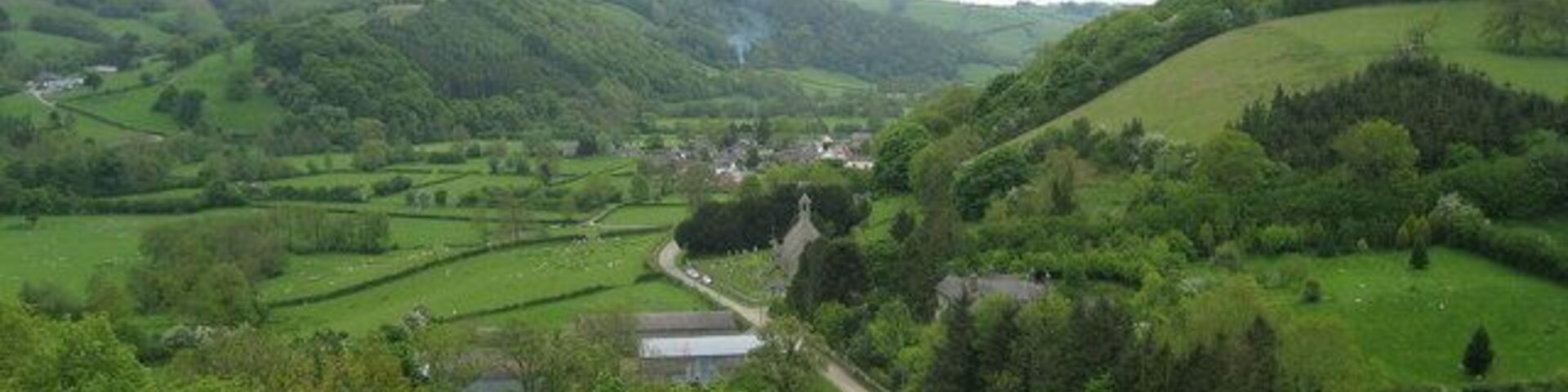 View over Newcastle Lovely aspect from the Offa's Dyke Path looking up the Clun Valley and Church Road to the small community of Newcastle in the Shropshire Hills.