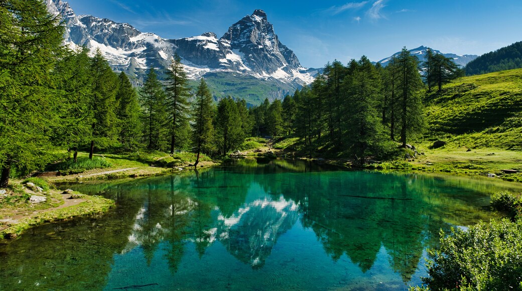 The blue lake and the Matterhorn in a scenic summer landscape with sunny lights seen from Breuil-Cervinia, Aosta Valley - Italy