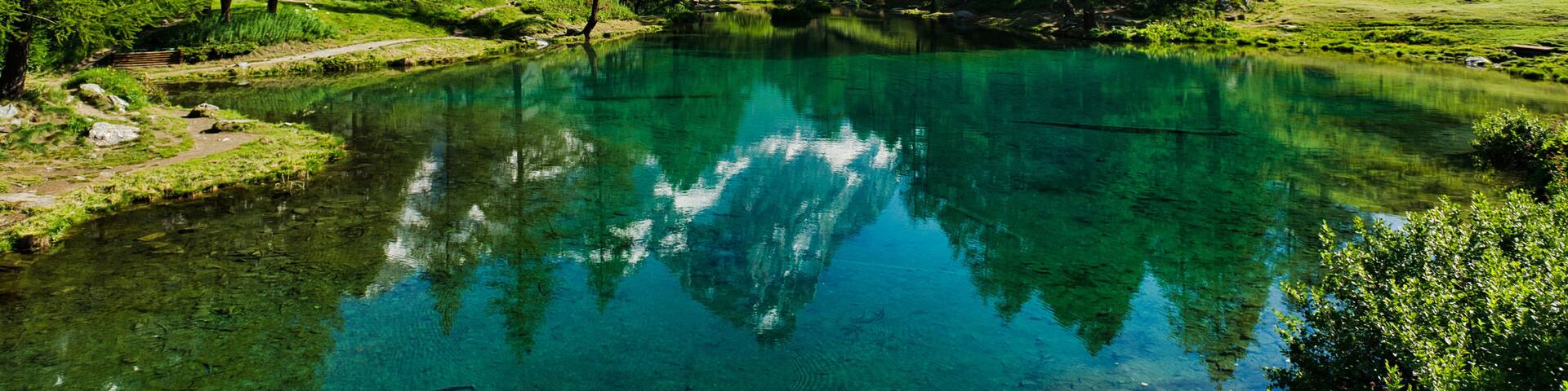 The blue lake and the Matterhorn in a scenic summer landscape with sunny lights seen from Breuil-Cervinia, Aosta Valley - Italy