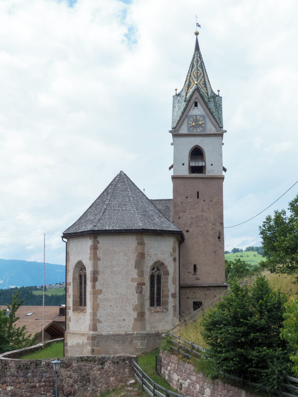A church with a bell tower and a smaller adjacent building.