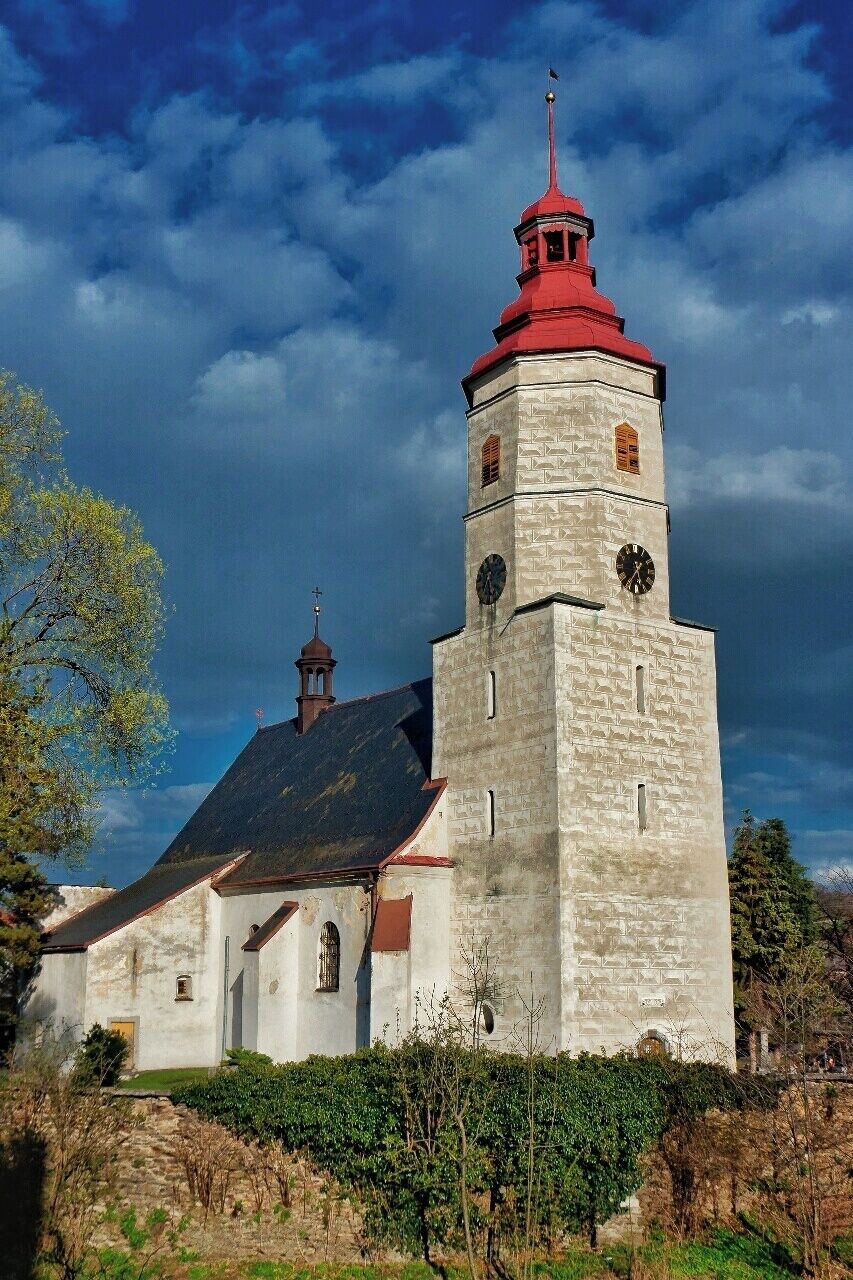 A church with a red spire and a clock tower.