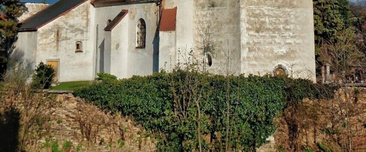 A church with a red spire and a clock tower.