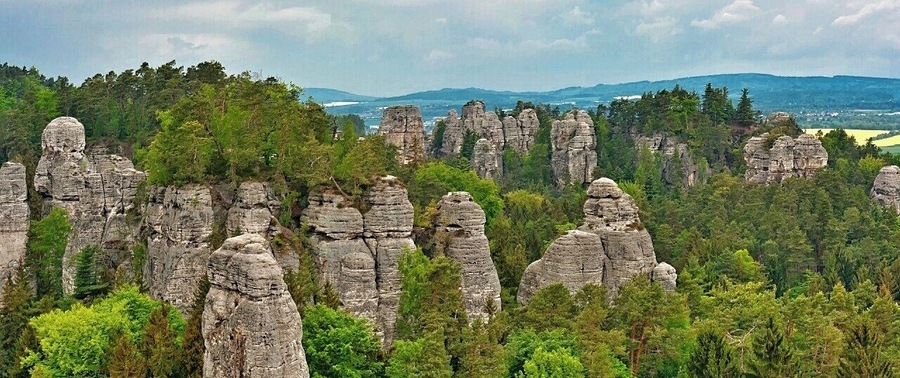 May 2015
Vyhlídka na Kapelu, Hrube rocks, Bohemian Paradise, Czech republic
Bohemian Paradise (=Český Ráj) is a nature reserve protected area established in 1955 and it is located in North Bohemia. It has a varied country side with plenty of first and beech surrounding wonderful sandstone rock formations. The water, wind and frost erosion has left many uniquely shaped rock towers having up to 60 meters of height and these are a popular place for Czech rock climbers for decades.
In the picture is the main part of Hrube rocks in Bohemian Paradise. This panoramic viewpoint is called View of the Orchestra. The Orchestra is the group of the sandstone towers on the left, with one needle standing before them, which is called the Dirigent. On the right in the background is the Lighthouse area with Lighthouse and Gate rocks.