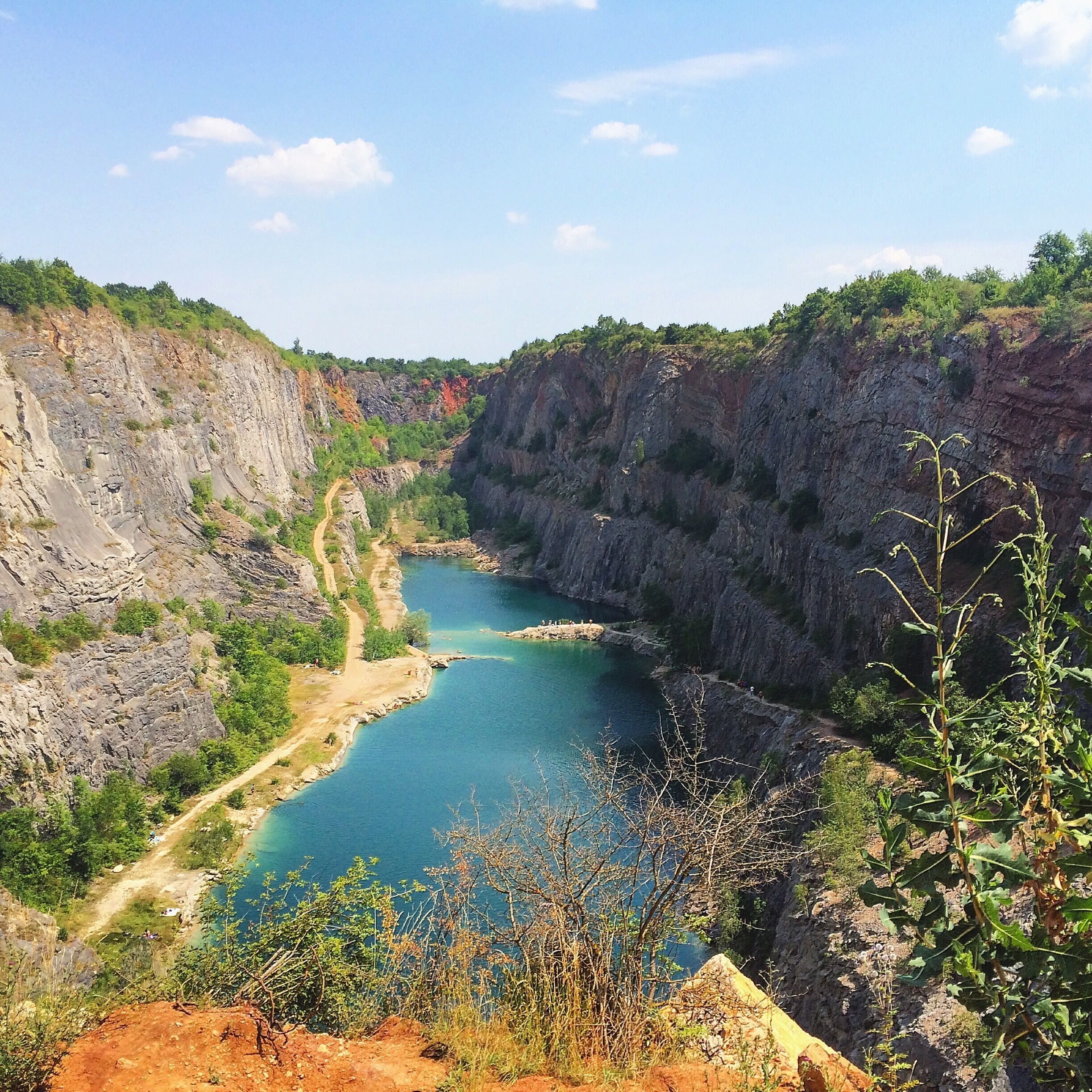 A river winding through a canyon with steep cliffs and sparse vegetation.