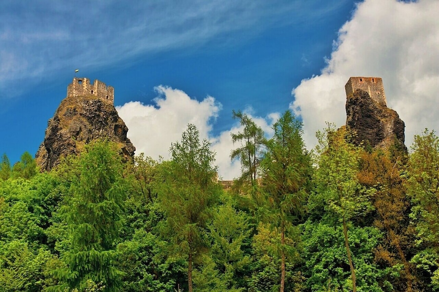 May 2015
Castle Trosky, Český ráj, Czech republic
Trosky is a castle ruin located some 75 km north from Prague in a natural reservation region called Český ráj (=Bohemian paradise) making a landmark of it. It is one of the most famous Czech castles and is situated on the summits of two basalt volcanic plugs. On the lower peak (47 m) is the two-storey structure called Baba (Old Woman), and on the higher outcrop (57 m) is the four-sided structure known as Panna (Virgin).
It was built in 1380 and was used for a century. It is a ruin since 1648 when it was burned down during the Thirty years war. Since 1928 a propery of the Club of Czech tourists and a popular tourist spot.
View from below, Virgin tower is on the left and Old Woman tower is on the right.