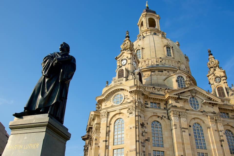 A statue of Martin Luther and a historic church with ornate architecture.