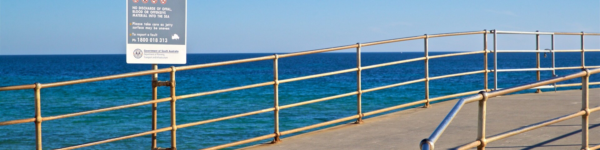 Brighton Beach which includes signage and general coastal views