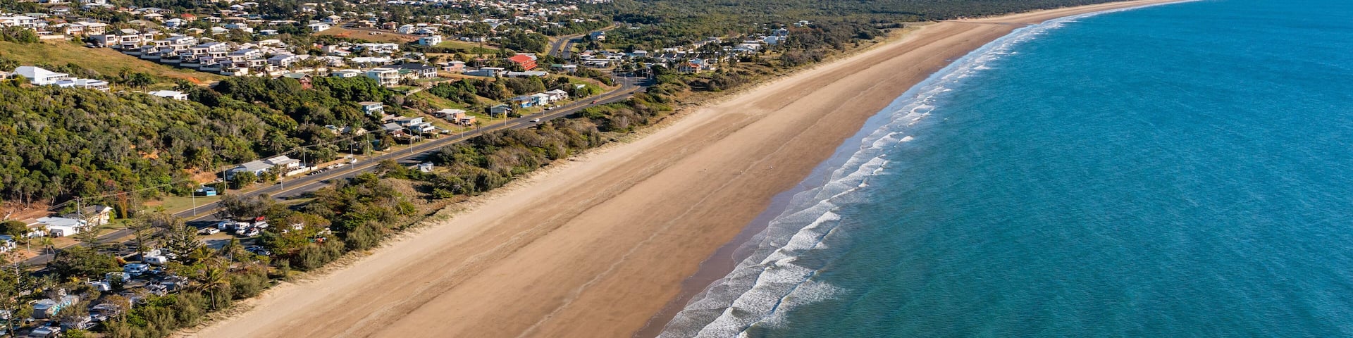 Yeppoon Beach showing landscape views, a coastal town and a beach