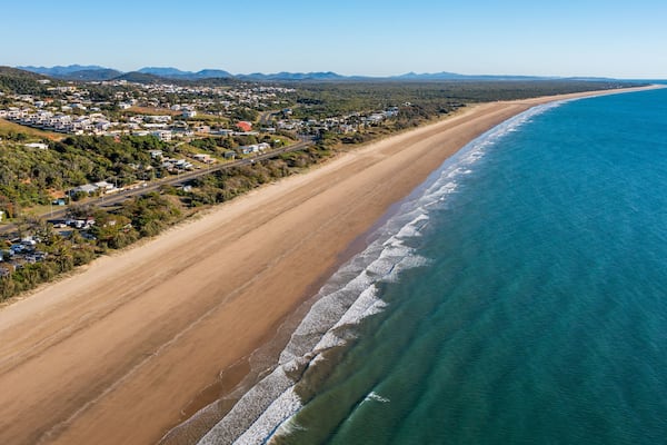 Yeppoon Beach showing landscape views, a coastal town and a beach