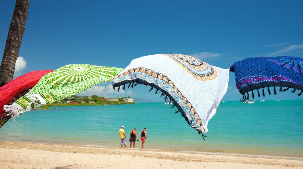 Airlie Beach showing a beach and a coastal town as well as a small group of people