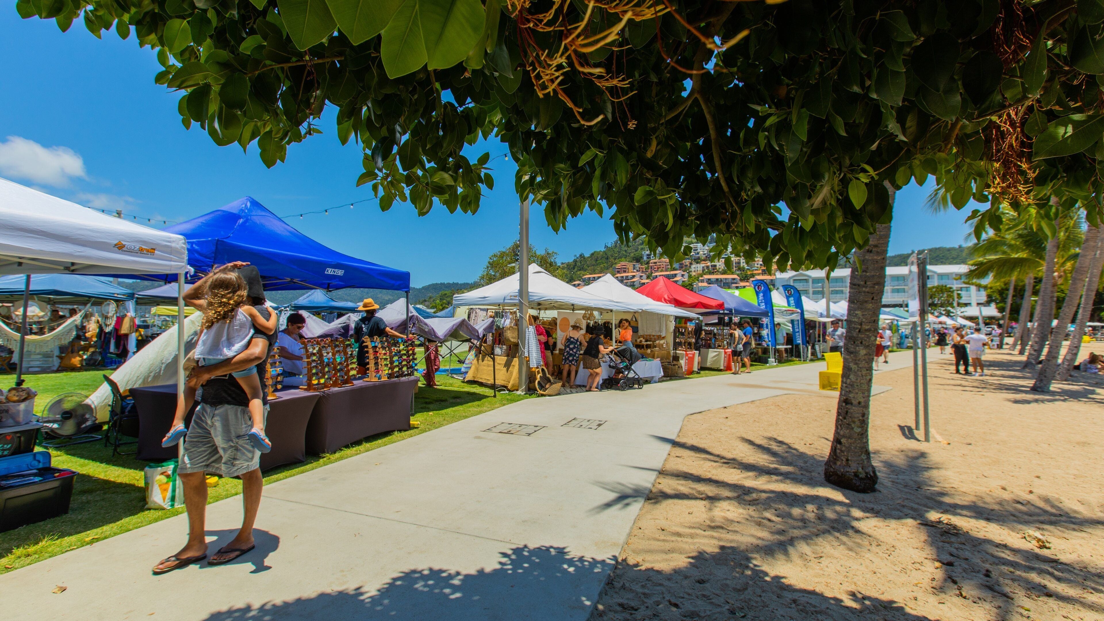 Airlie Beach Market featuring markets as well as a family