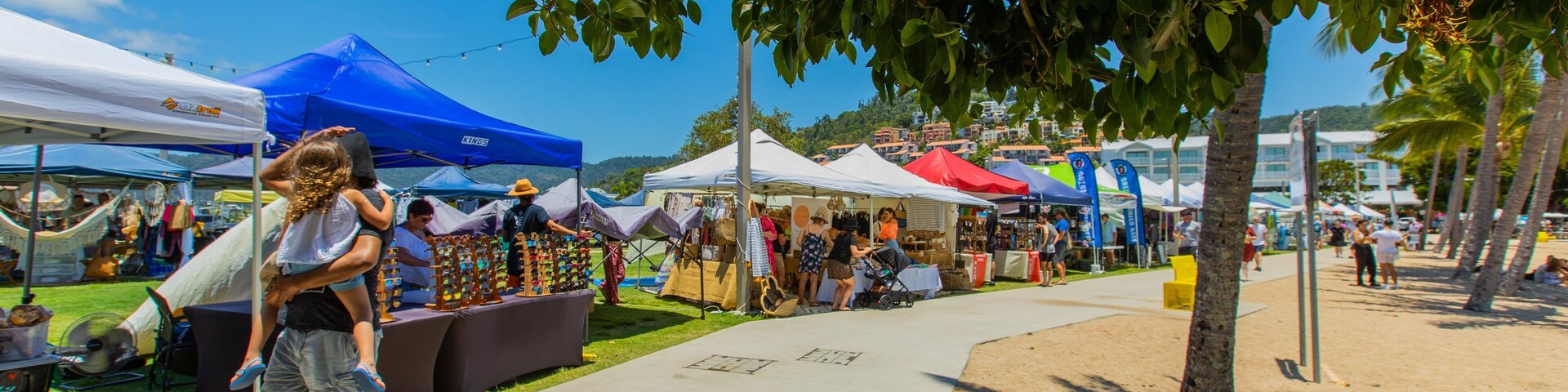 Airlie Beach Market featuring markets as well as a family