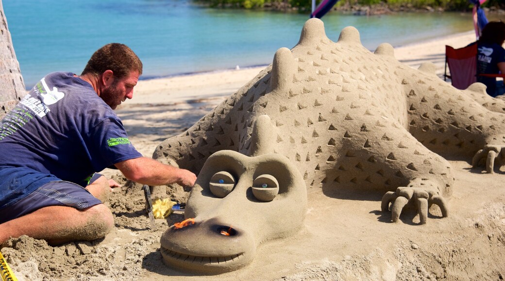 Airlie Beach which includes outdoor art and a sandy beach as well as an individual male