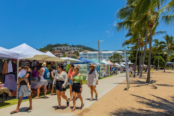 Airlie Beach Market featuring markets and street scenes as well as a small group of people