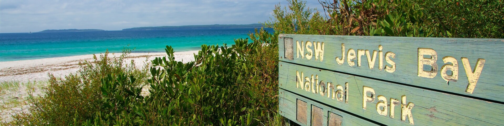 Jervis Bay National Park which includes general coastal views, signage and a beach