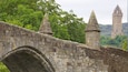 A stone bridge with pointed arches and stone towers.