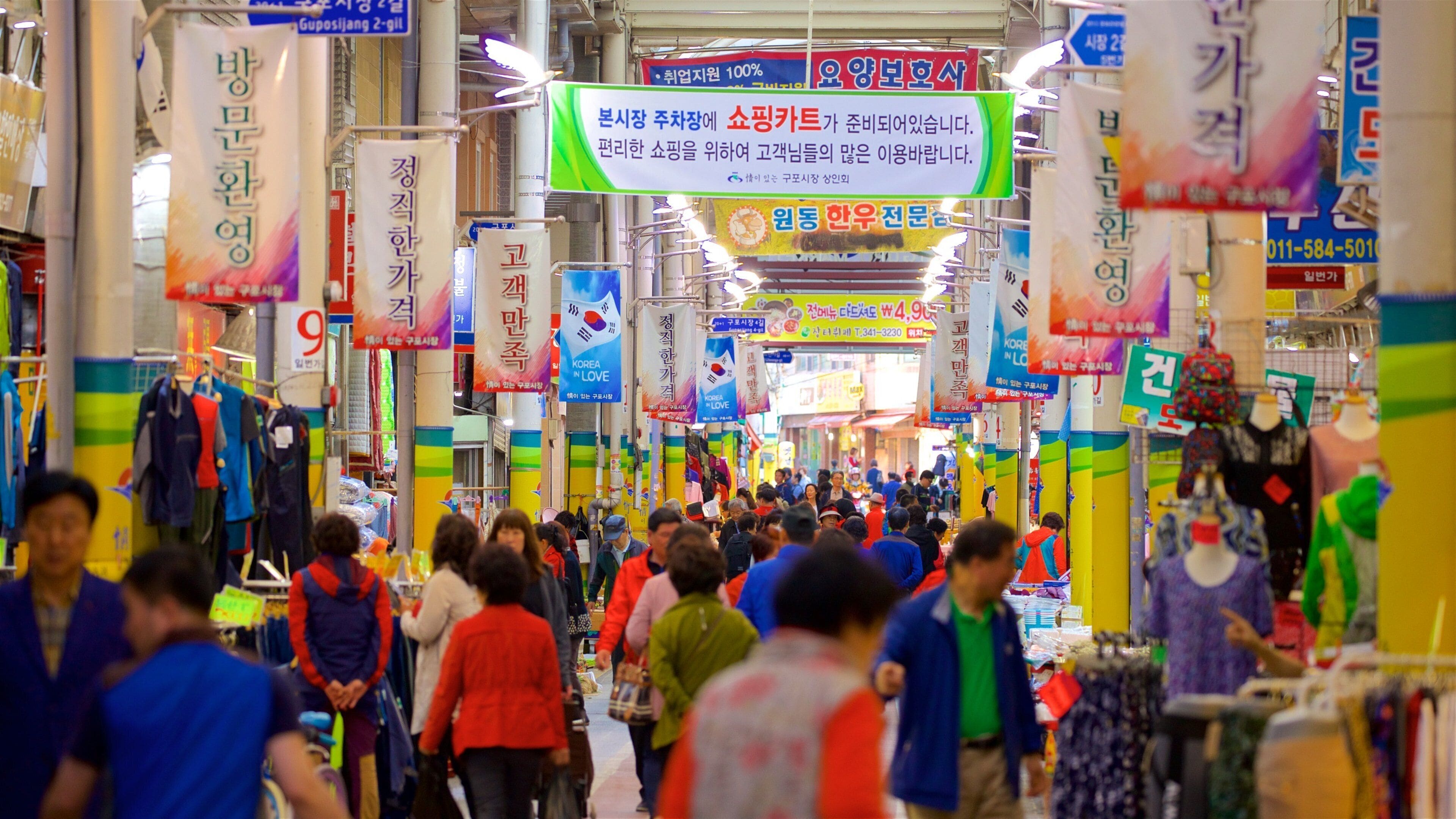 Busan which includes signage, interior views and markets