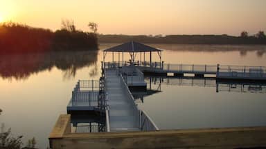 Champaign which includes a sunset and a lake or waterhole