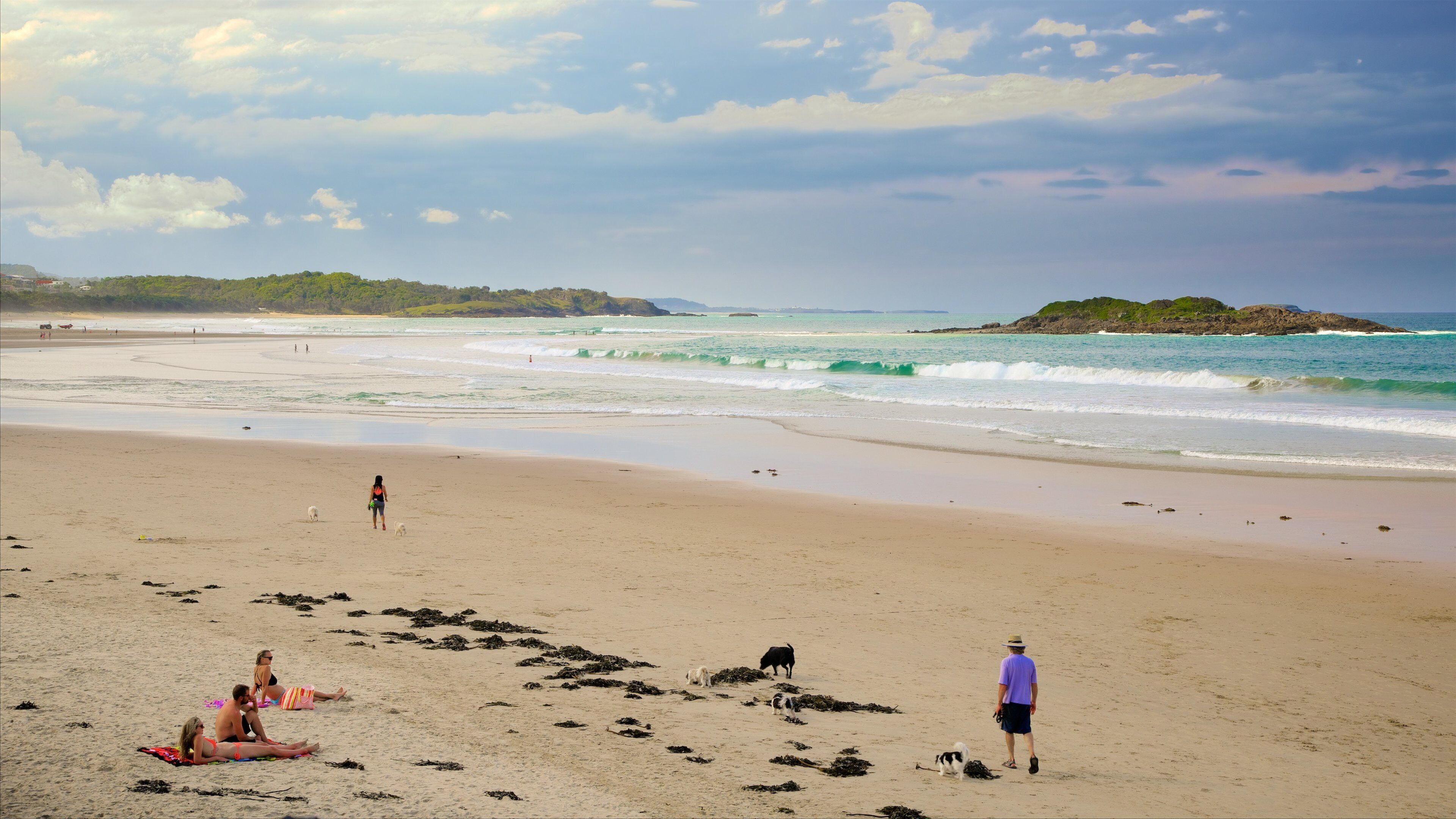 Coffs Harbour which includes a sandy beach as well as a small group of people