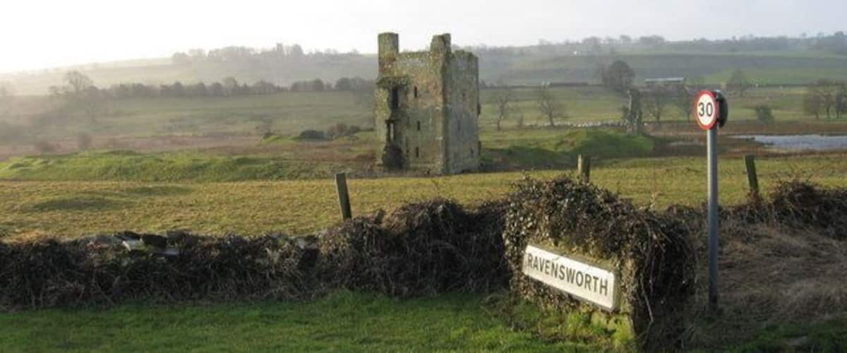 A rural landscape with a sign reading "Ravensworth" and a speed limit sign of 30.