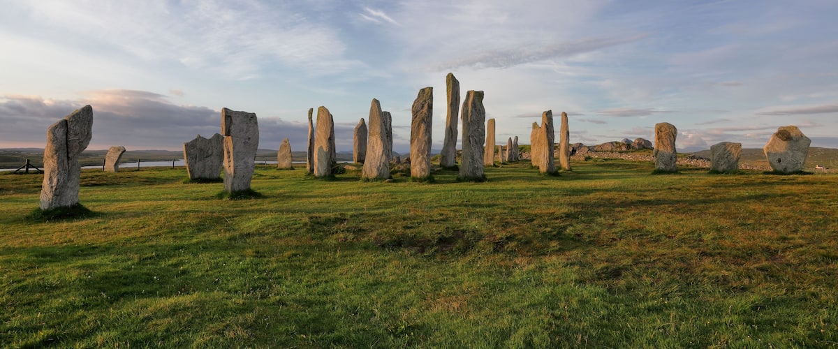 A field of standing stones under a cloudy sky.