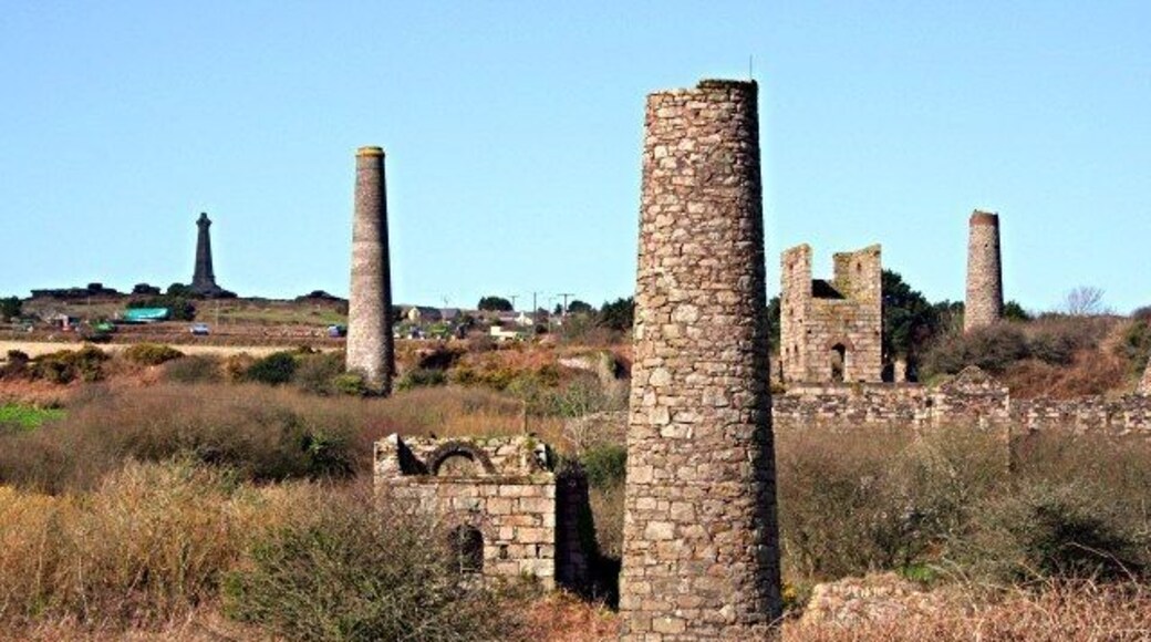 West Basset Stamps This is the remains of the buildings which housed machinery to crush, grade and concentrate the ore to make it ready for sale. On the horizon at the top of Carn Brea Hill is the De Dunstanville Memorial, a memorial to one of the Bassett family. The Bassetts were big landowners hereabouts in the 19th century. Landowners were just about the only people who were guaranteed to get rich from mining as they took a percentage of everything sold without having to invest a penny in any mines on their land.