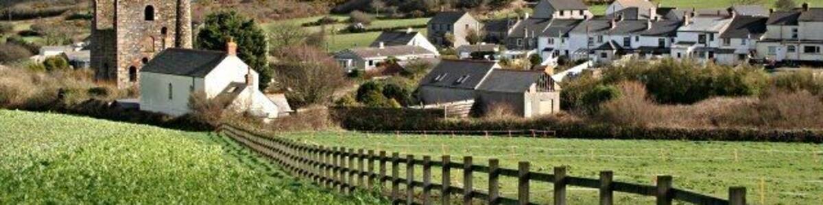 Down to Carnkie The subject grid reference is for the cottage at the end of the fence. This view, taken from the lower southern slope of Carn Brea, looks into the south-eastern corner of this grid square and beyond to the other side of the valley and Wheal Bassett mine on the far hillside.