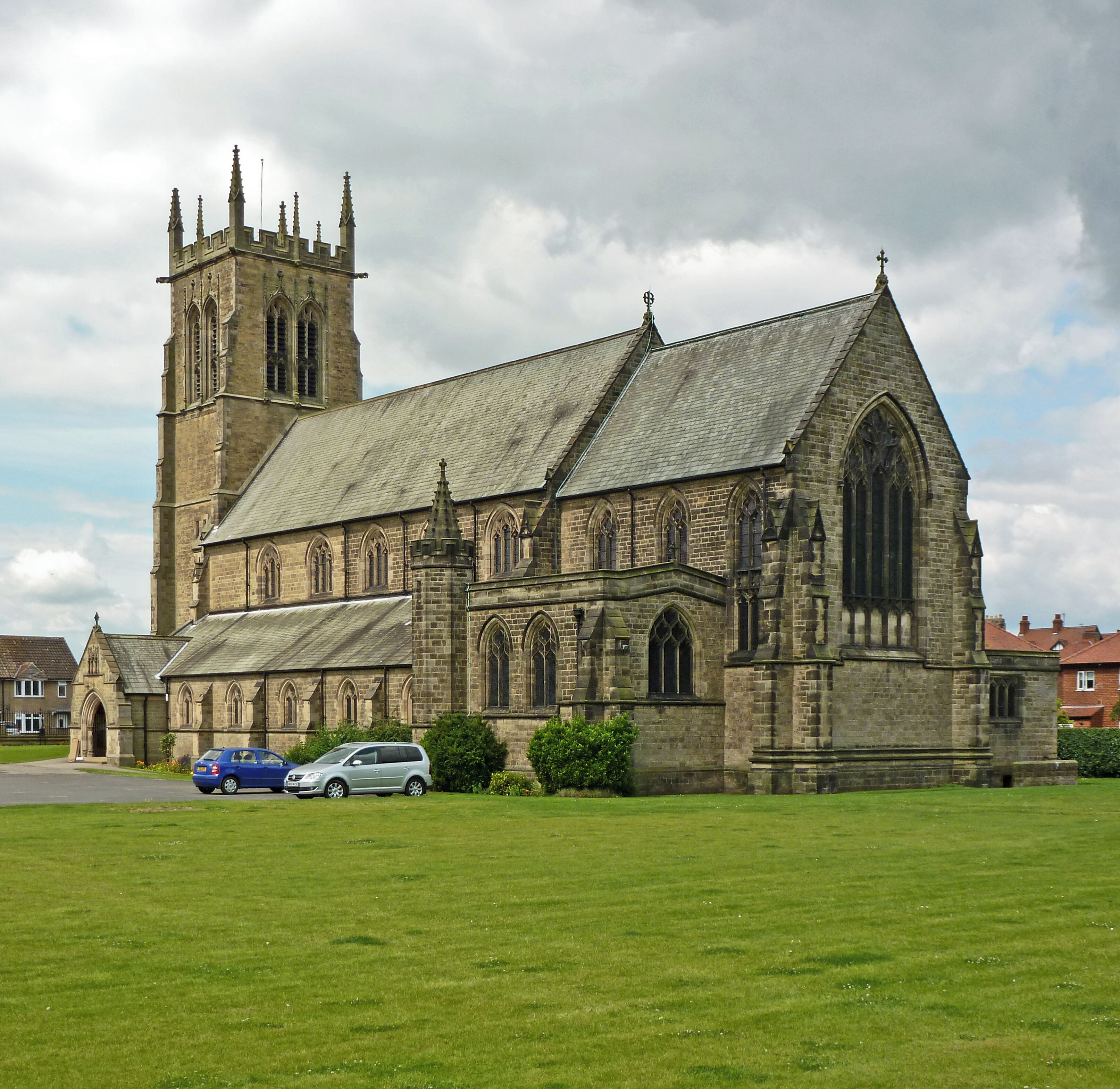 A large stone church with a prominent tower and arched windows.