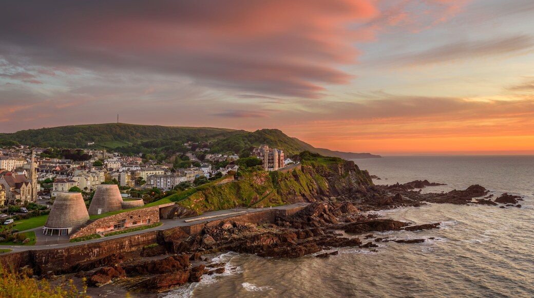 A scenic view of the coastal town of Ilfracombe, North Devon, England from Capstone Hill at sunset.