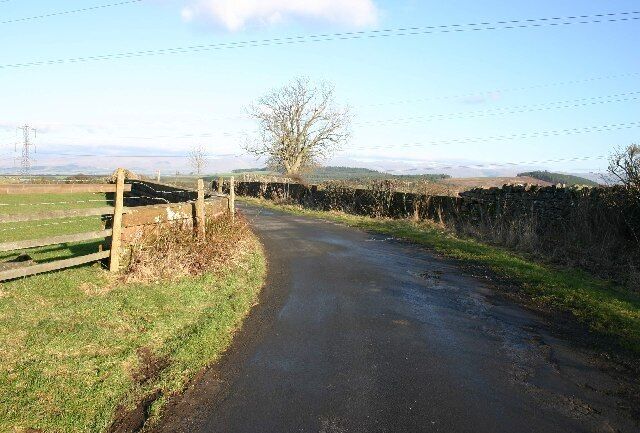 Bridge Over Disappeared Railway. The OS map clearly shows a dismantled line here, but the old cutting has been filled up the road level. Compare with NY5425 where an unmarked line is clearly visible on the ground.