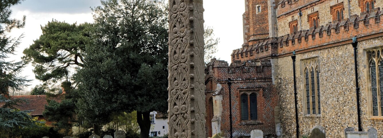 The Grade II listed 20th-century Second World War memorial cross, erected on a 12th-century shaft at the south-east of the graveyard of St Nicholas' Church in Castle Hedingham in Essex, England. Camera: Canon EOS 6D with Canon EF 24-105mm F4L IS USM lens. Software: large RAW file lens-corrected, optimized and downsized with DxO OpticsPro 10 Elite, Viewpoint 2, and Adobe Photoshop CS2.