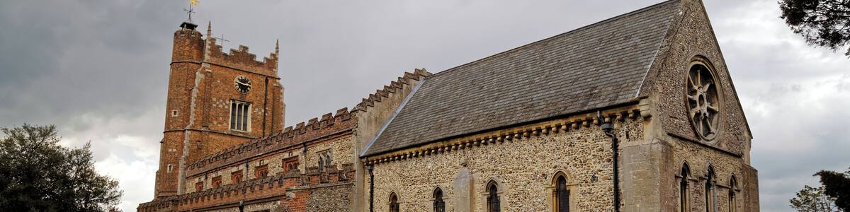 A south-east view of the churchyard, path, and Norman Romanesque chancel of St Nicholas' Church in Castle Hedingham in Essex, England. Camera: Canon EOS 6D with Canon EF 24-105mm F4L IS USM lens. Software: large RAW file lens-corrected, optimized and downsized with DxO OpticsPro 10 Elite, Viewpoint 2, and Adobe Photoshop CS2.