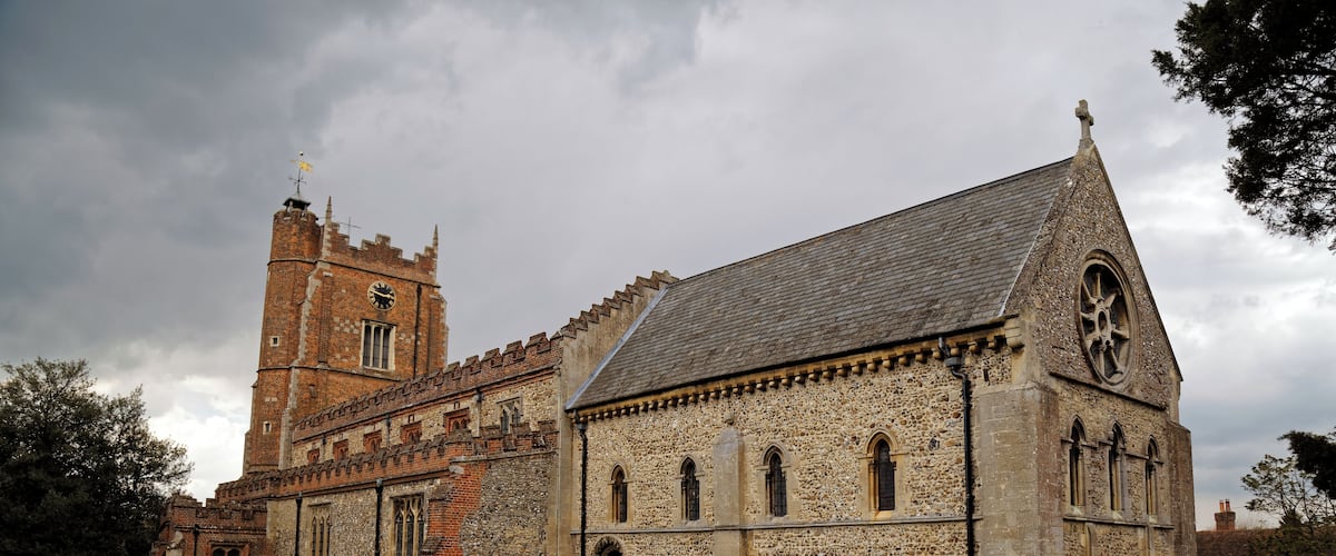 A south-east view of the churchyard, path, and Norman Romanesque chancel of St Nicholas' Church in Castle Hedingham in Essex, England. Camera: Canon EOS 6D with Canon EF 24-105mm F4L IS USM lens. Software: large RAW file lens-corrected, optimized and downsized with DxO OpticsPro 10 Elite, Viewpoint 2, and Adobe Photoshop CS2.