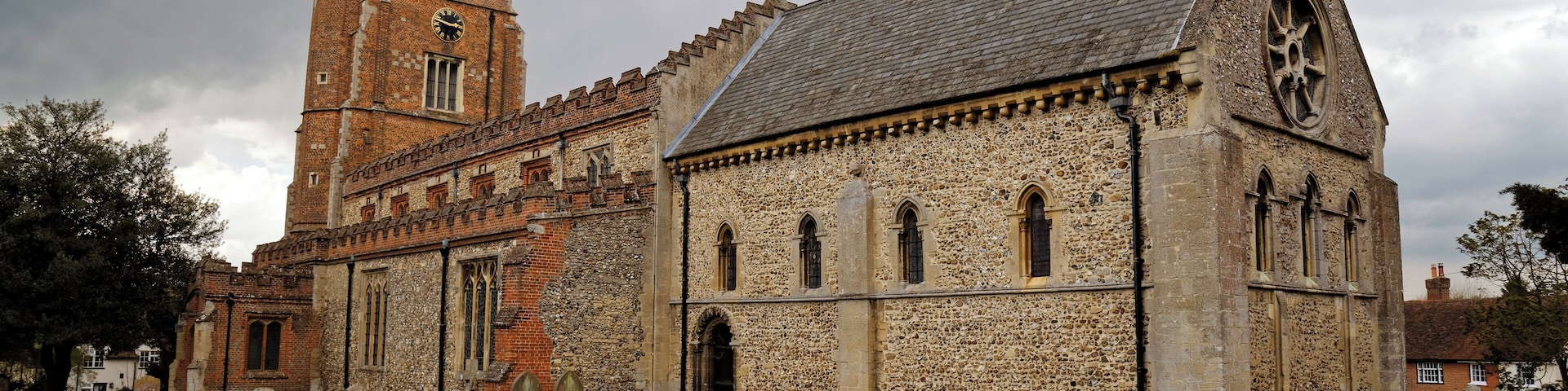 A south-east view of the churchyard, path, and Norman Romanesque chancel of St Nicholas' Church in Castle Hedingham in Essex, England. Camera: Canon EOS 6D with Canon EF 24-105mm F4L IS USM lens. Software: large RAW file lens-corrected, optimized and downsized with DxO OpticsPro 10 Elite, Viewpoint 2, and Adobe Photoshop CS2.