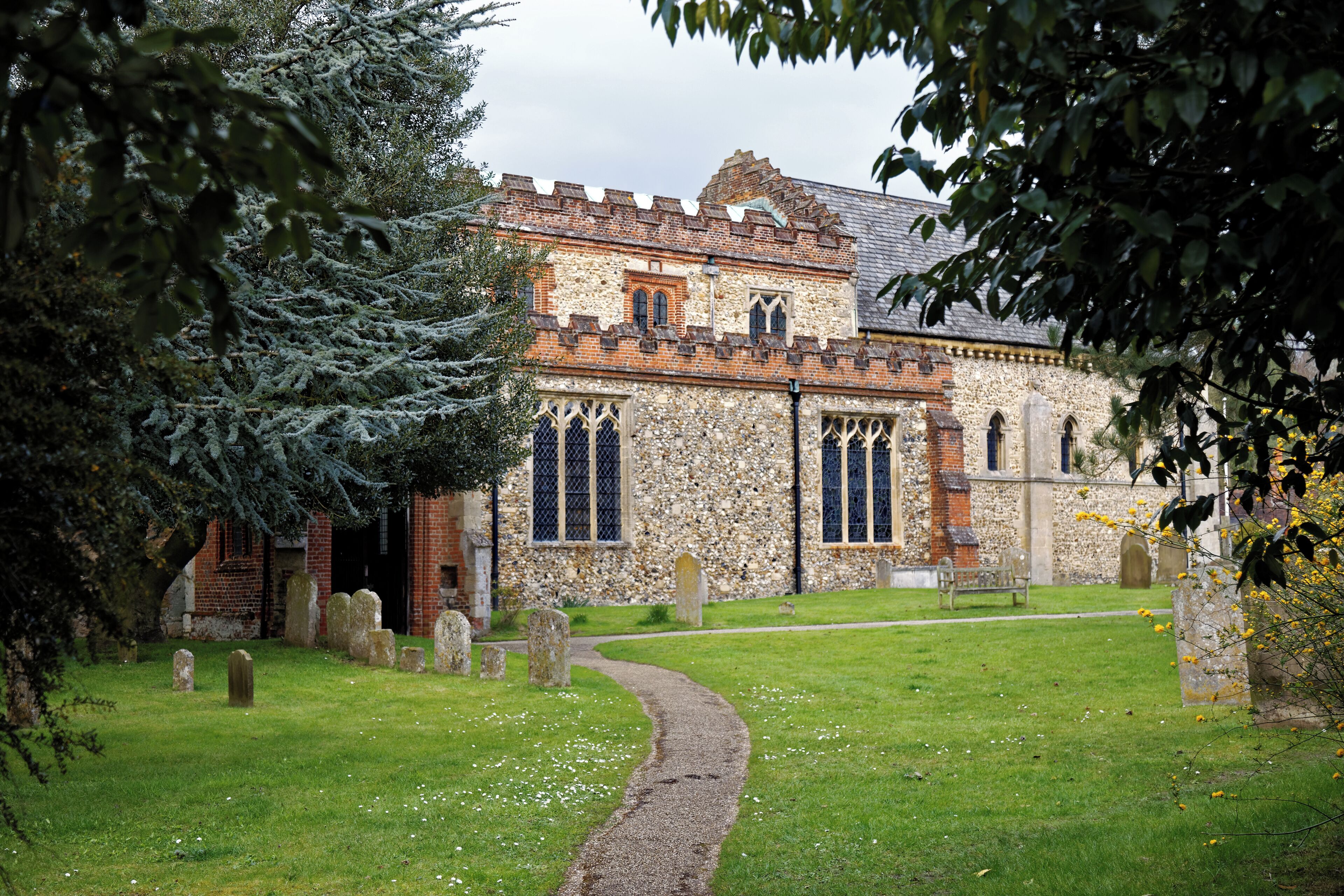 The south aisle, clerestory, chancel and churchyard path of St Nicholas' Church in Castle Hedingham in Essex, England. Camera: Canon EOS 6D with Canon EF 24-105mm F4L IS USM lens. Software: large RAW file lens-corrected, optimized and downsized with DxO OpticsPro 10 Elite, Viewpoint 2, and Adobe Photoshop CS2.