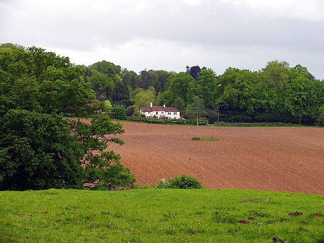 Farmland and Frilsham. This photograph looks across the south eastern section of the grid square incorporating farmland, woodland and residences, typical of this grid square.