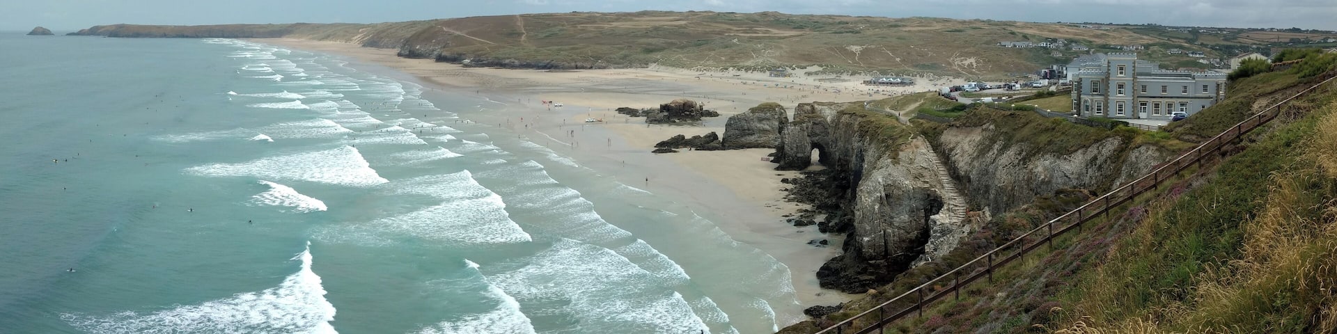 Perran Beach, near Perranporth, Cornwall, UK, at mid-tide, looking north. Ligger Point headland in the distance, on the left, Droskyn Castle hotel on the right, the town of Perranporth hidden behind it.