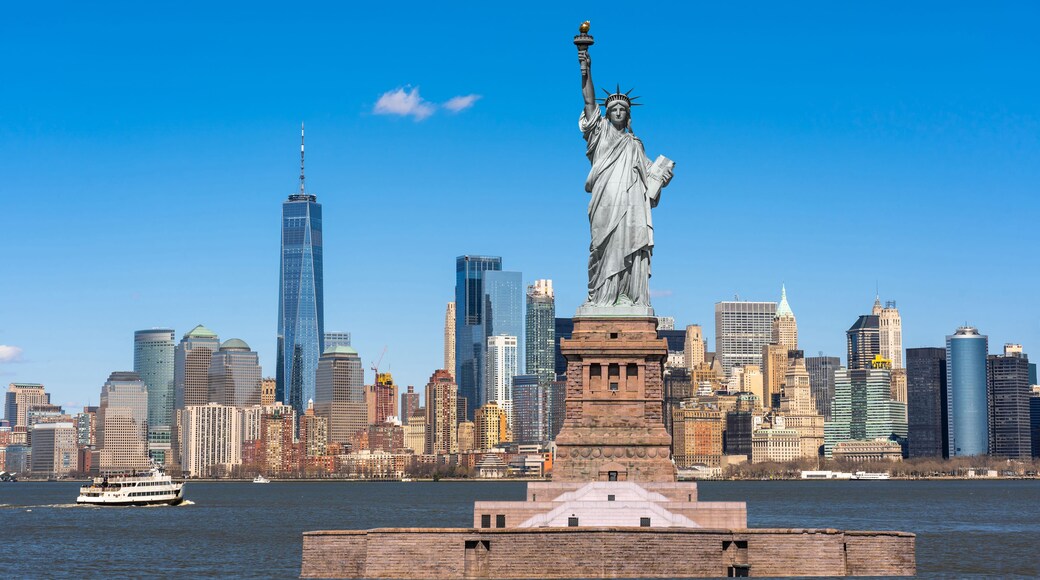The Statue of Liberty over the New York cityscape river side which location is lower manhattan, United state of America, USA, Architecture and building with tourist concept