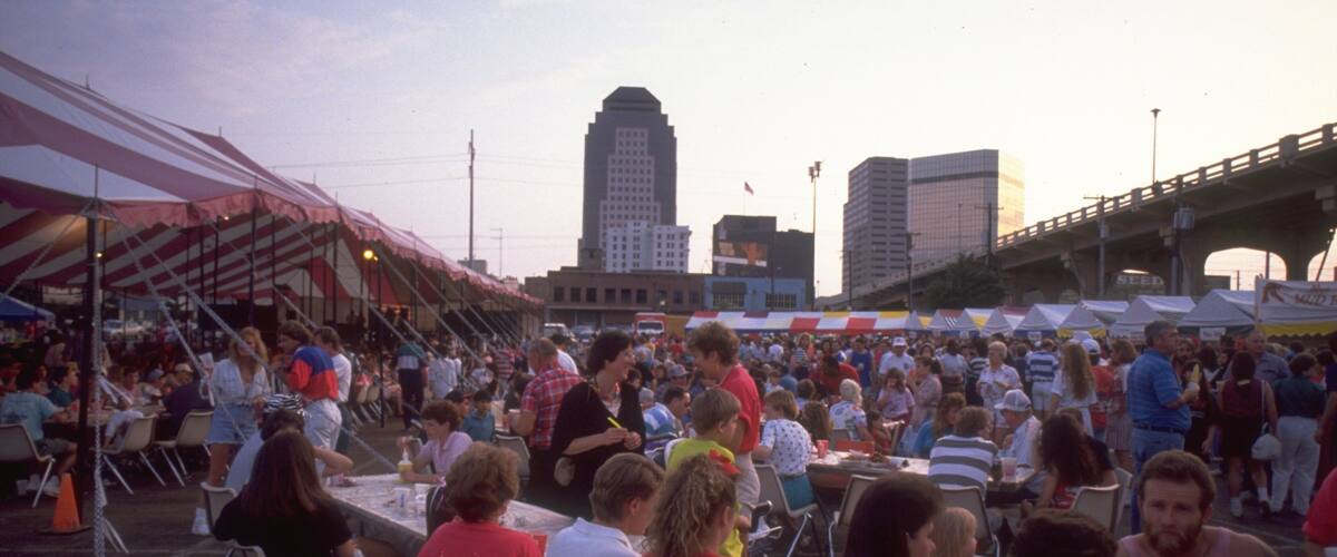 Shreveport Festival Plaza featuring a sunset and outdoor eating as well as a large group of people