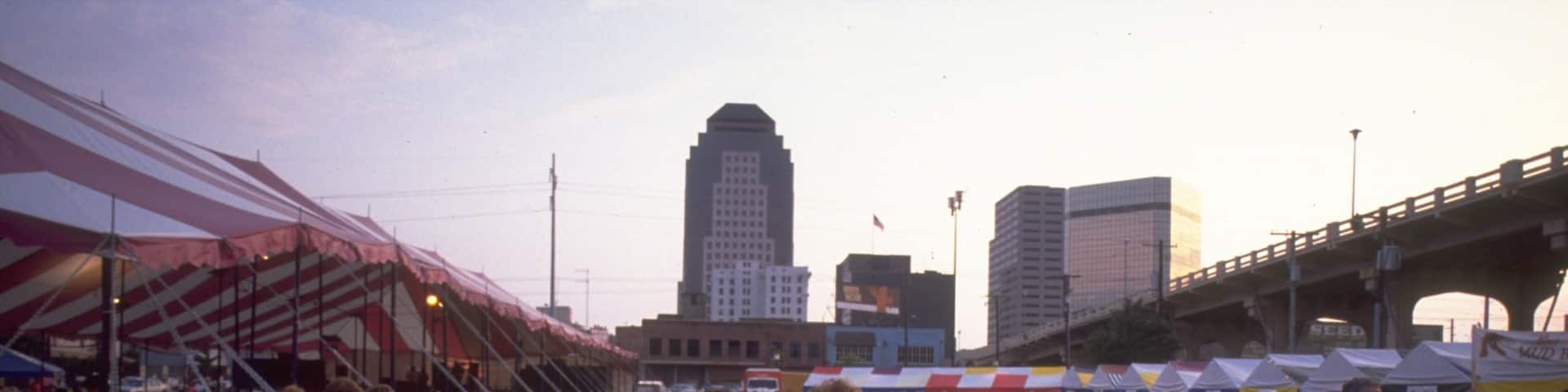 Shreveport Festival Plaza featuring a sunset and outdoor eating as well as a large group of people
