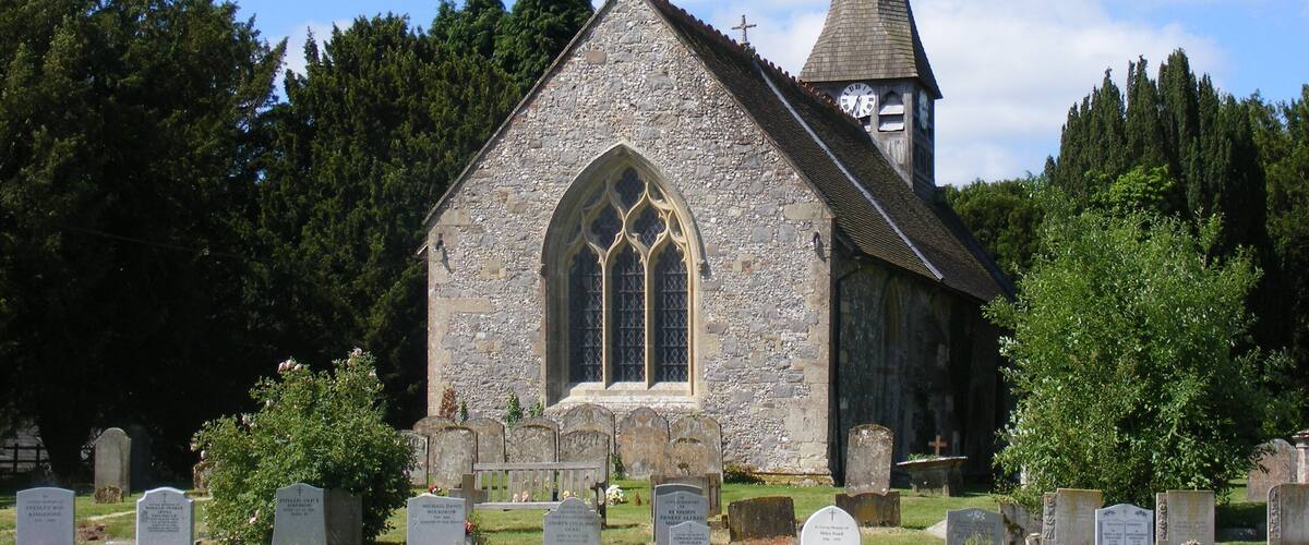 A church with a tall steeple and a clock tower.