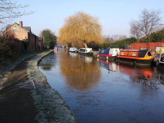 Crisp, Cold, Christleton Canal. Quite a frosty morning on the Shropshire Union Canal, near Christleton. A small marina on the right, with one of the boats showing signs of life, with smoke coming out of the chimney.