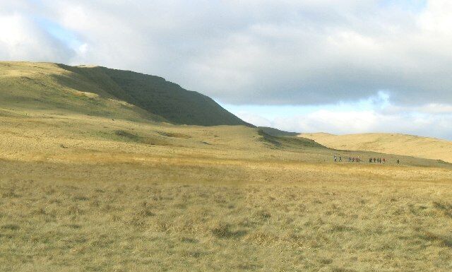Walkers on Fan Hir. The view north toward Fan Hir shows the drop off to the east face in shadow, and a party of walkers on their way back down.