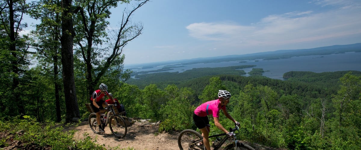 Lake Ouachita State Park showing tranquil scenes and mountain biking as well as a couple