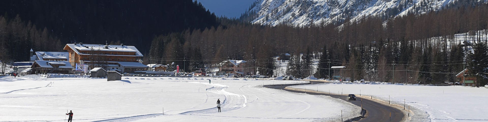 A snow-covered ski resort with mountains in the background.