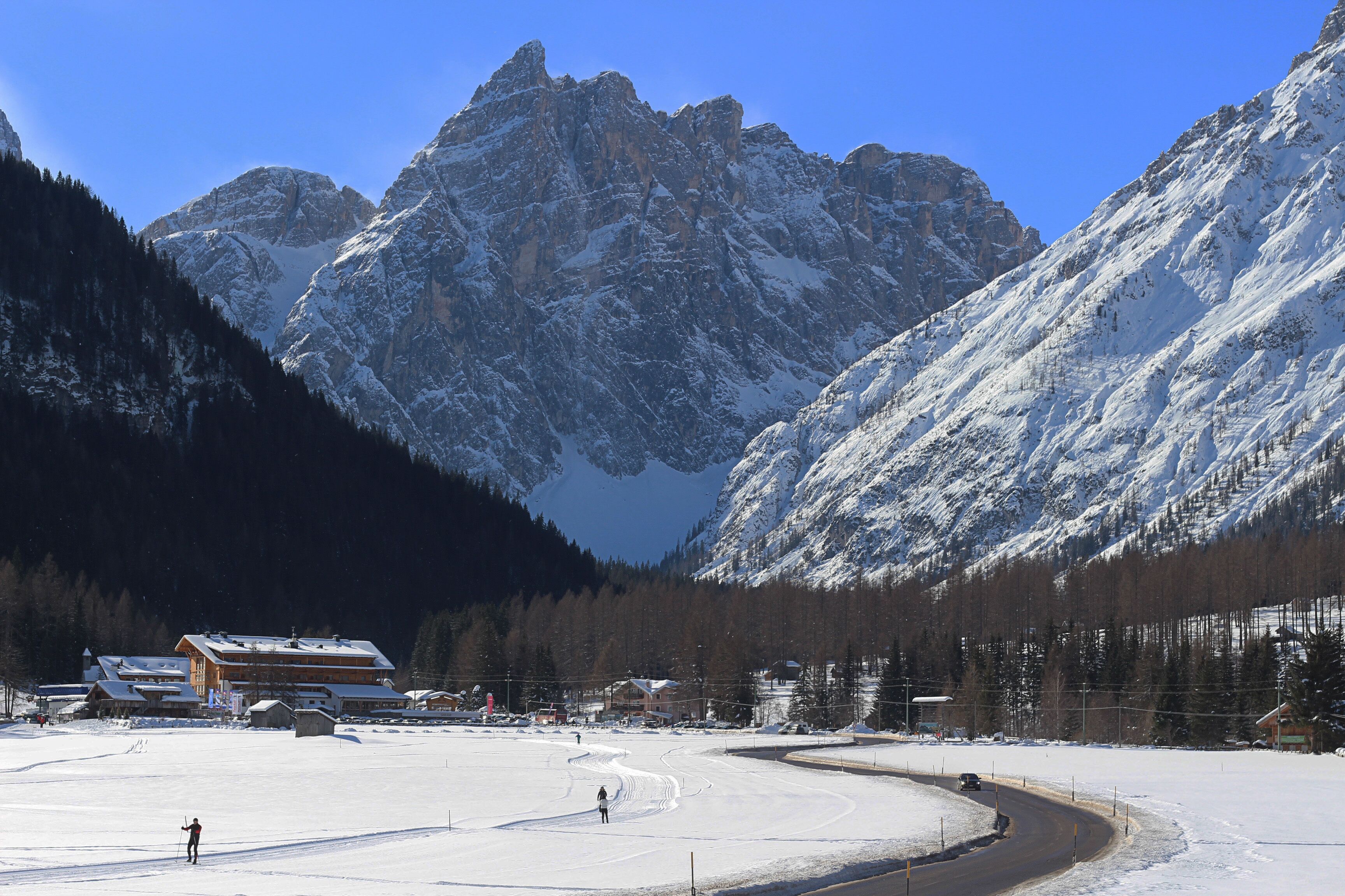A snow-covered ski resort with mountains in the background.